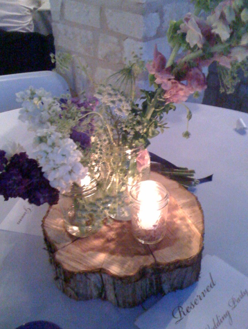 Wildflowers candles and wood cuts created rustic centerpieces
